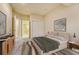 A cozy main bedroom featuring neutral tones, a large closet, and an ensuite bathroom at 5080 Barn Swallow Way, Parker, CO 80134