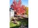 Aerial view of a well-manicured backyard with a stone patio and mature trees in fall colors at 4921 Fountain St, Boulder, CO 80304