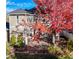 Aerial view of backyard with stone patio, lush lawn, mature tree, and white picket fence at 4921 Fountain St, Boulder, CO 80304