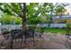 Secluded backyard with stone patio, lush lawn, mature trees, and a white picket fence at 4921 Fountain St, Boulder, CO 80304