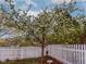 Landscaped backyard featuring a flowering tree, white picket fence, and well-maintained lawn at 4921 Fountain St, Boulder, CO 80304