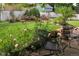 Serene backyard garden with lush greenery, blooming flowers, a white fence and comfortable outdoor seating at 4921 Fountain St, Boulder, CO 80304