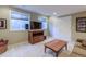 Finished basement with an entertainment unit and comfortable seating area for relaxing at 4921 Fountain St, Boulder, CO 80304
