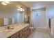 Well-lit bathroom with a double sink vanity, tub and a window providing natural light at 4921 Fountain St, Boulder, CO 80304