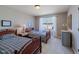 Bright bedroom featuring two twin beds, a side table, and a large window with natural light at 4921 Fountain St, Boulder, CO 80304