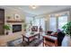Cozy living room with fireplace, hardwood floors, and large windows at 4921 Fountain St, Boulder, CO 80304