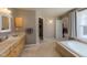 Bathroom with a soaking tub, double vanity, and a walk-in closet, providing ample space at 4921 Fountain St, Boulder, CO 80304