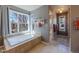 Bathroom featuring a large window above a soaking tub, letting in natural light at 4921 Fountain St, Boulder, CO 80304