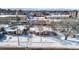 Aerial view of house in snowy residential neighborhood, showing backyard and street view at 1435 Quebec St, Denver, CO 80220