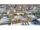 Aerial view of two adjacent lots with houses, snowy setting at 1435 Quebec St, Denver, CO 80220