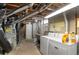 Unfinished basement with laundry and HVAC systems at 1435 Quebec St, Denver, CO 80220