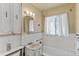 Small bathroom with vintage vanity and tiled walls at 1435 Quebec St, Denver, CO 80220