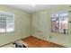 Bedroom with hardwood floors and two windows at 1435 Quebec St, Denver, CO 80220