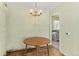 Simple dining room with wood table and chandelier at 1435 Quebec St, Denver, CO 80220