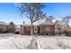Brick house exterior, snowy front yard, walkway to entrance at 1435 Quebec St, Denver, CO 80220