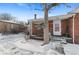 Brick house exterior, snowy front yard, walkway to entrance at 1435 Quebec St, Denver, CO 80220