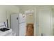 Kitchen with white refrigerator and view into dining area at 1435 Quebec St, Denver, CO 80220