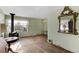 Living room with hardwood floors, wood burning stove, and large ornate mirror at 1435 Quebec St, Denver, CO 80220