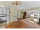 Living room with hardwood floors and kitchen view at 1435 Quebec St, Denver, CO 80220