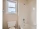 Bright bathroom featuring a white tiled shower-tub combination with window at 2215 Parkview Dr, Longmont, CO 80504