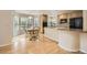 Eat-in kitchen featuring light wood cabinets and a breakfast nook with backyard views at 2215 Parkview Dr, Longmont, CO 80504