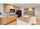 Well-lit kitchen featuring ample wood cabinetry, neutral countertops, and modern appliances at 2215 Parkview Dr, Longmont, CO 80504