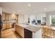Bright kitchen with light wood cabinets, an island with sink, and an adjacent breakfast nook at 2215 Parkview Dr, Longmont, CO 80504