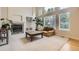 Spacious living room with a fireplace, built-in shelving, and large windows at 2215 Parkview Dr, Longmont, CO 80504
