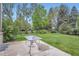 Outdoor patio area includes a table, green lawn, and lush landscaping at 2215 Parkview Dr, Longmont, CO 80504