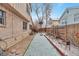 Side yard with a basketball hoop and a row of landscaping at 710 Kittredge St, Aurora, CO 80011