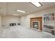 Cozy finished basement with a brick fireplace, built-in shelving, and comfortable carpeting at 710 Kittredge St, Aurora, CO 80011