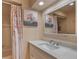 Updated bathroom with a shower, tub, and a decorative mirror at 710 Kittredge St, Aurora, CO 80011