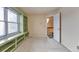 Bedroom with window seat and built-in shelves looking out to the hall at 710 Kittredge St, Aurora, CO 80011
