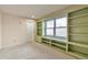 Cozy bedroom featuring built-in bookshelves and a window seat for natural light at 710 Kittredge St, Aurora, CO 80011