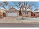 Charming single-story brick home featuring a two-car garage and manicured front yard at 710 Kittredge St, Aurora, CO 80011
