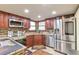 Modern kitchen features stainless steel appliances, granite countertops, and ample cabinet space at 710 Kittredge St, Aurora, CO 80011