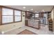 Updated kitchen with stainless steel appliances, dark wood cabinets, and tile backsplash at 710 Kittredge St, Aurora, CO 80011