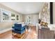 Living room features hardwood floors, white couch, and blue armchair at 4922 Meade St, Denver, CO 80221