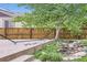 Backyard landscape featuring stamped concrete patio, small stream, decorative rock and mature tree at 853 Jenny Ln, Berthoud, CO 80513
