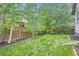 Landscaped backyard with green grass and wooden fence at 853 Jenny Ln, Berthoud, CO 80513