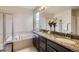 Bright bathroom featuring double sinks, granite countertops, and separate shower at 853 Jenny Ln, Berthoud, CO 80513