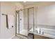 Bathroom featuring a glass enclosed shower and soaking tub at 853 Jenny Ln, Berthoud, CO 80513