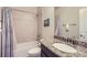 Bathroom featuring a tub with tile surround and a granite vanity at 853 Jenny Ln, Berthoud, CO 80513