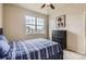 Bedroom with a queen bed, ceiling fan and a large window at 853 Jenny Ln, Berthoud, CO 80513