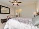 Bright bedroom with plush carpet, ceiling fan and large black mirror at 853 Jenny Ln, Berthoud, CO 80513