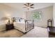 Neutral bedroom with large window, ceiling fan, and brass colored iron bed frame at 853 Jenny Ln, Berthoud, CO 80513