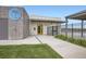 View of the community clubhouse exterior featuring 'The Club' sign, entrance and black metal fence at 853 Jenny Ln, Berthoud, CO 80513
