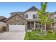 Charming two-story home with stone accents, green shutters, and a beautifully landscaped front yard at 853 Jenny Ln, Berthoud, CO 80513