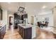 Open-concept kitchen featuring stainless steel appliances, granite countertops, and a view of the dining area at 853 Jenny Ln, Berthoud, CO 80513
