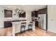 Modern kitchen featuring stainless steel appliances, granite countertops, and dark wood cabinets at 853 Jenny Ln, Berthoud, CO 80513